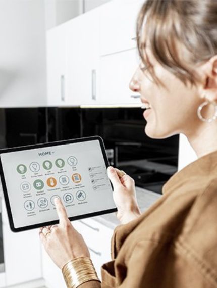 Women in Lakewood, CO Using A Tablet After a Smart Home Electrical Installation
