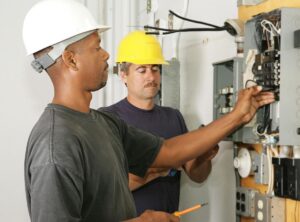 Electrical contractors working on an electrical panel in Wheat Ridge, CO