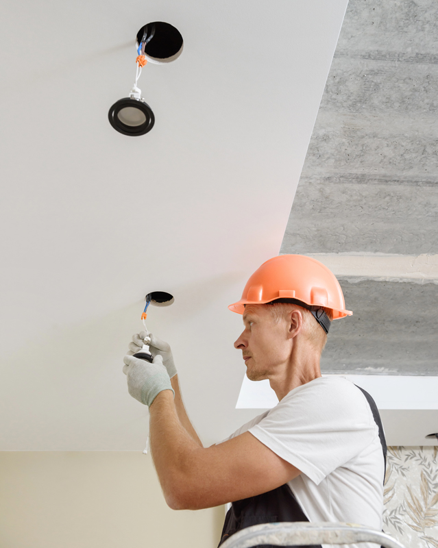 technician with a orange safety helmet providing Lighting Installation in Littleton